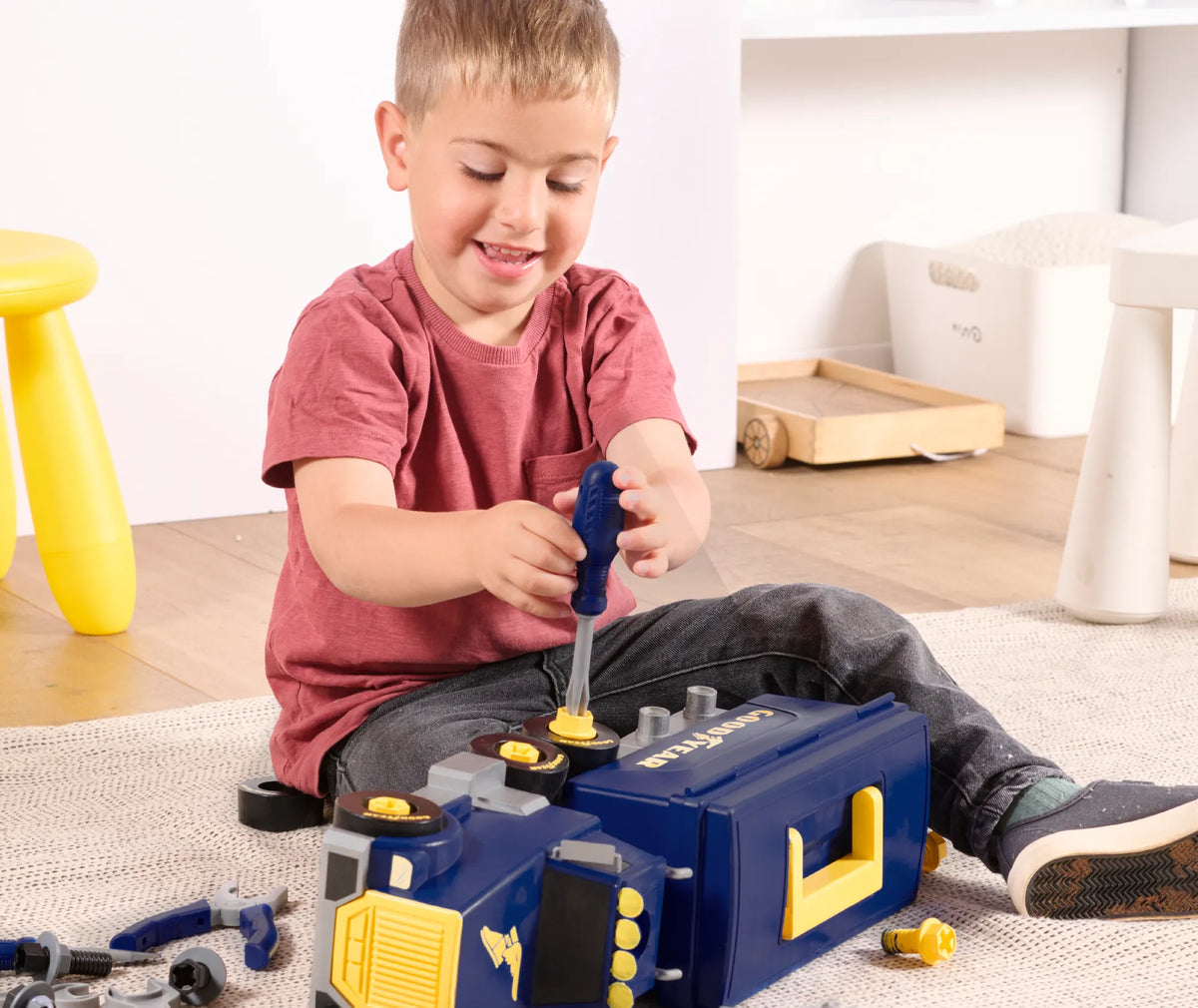 A boy taking apart a Goodyear toy engine set